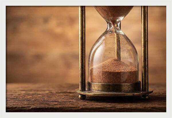Antique Hourglass On Wood Surface