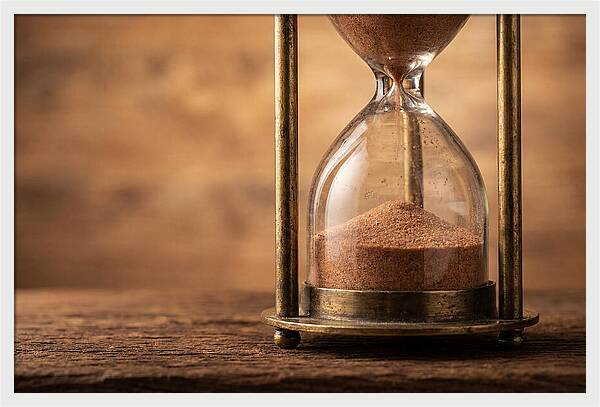 Antique Hourglass On Wood Surface