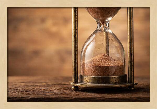 Antique Hourglass On Wood Surface