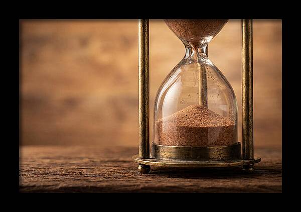 Antique Hourglass On Wood Surface
