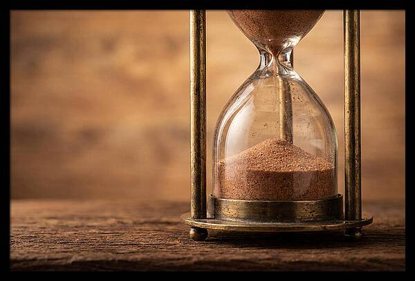 Antique Hourglass On Wood Surface