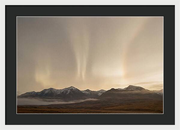 Aurora Pillars Rising Above Mountains