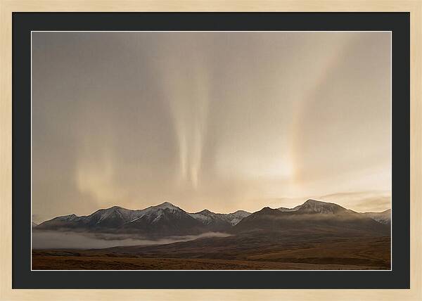 Aurora Pillars Rising Above Mountains