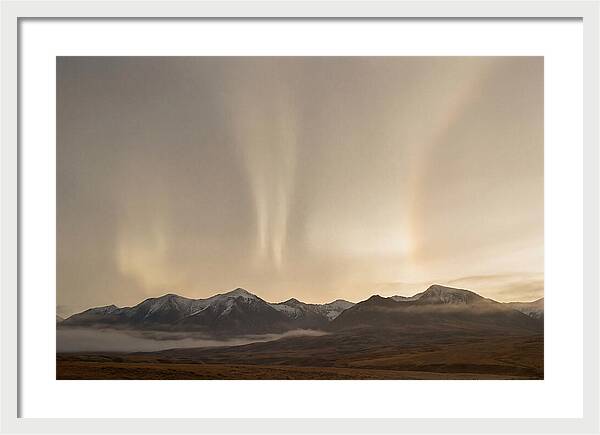 Aurora Pillars Rising Above Mountains