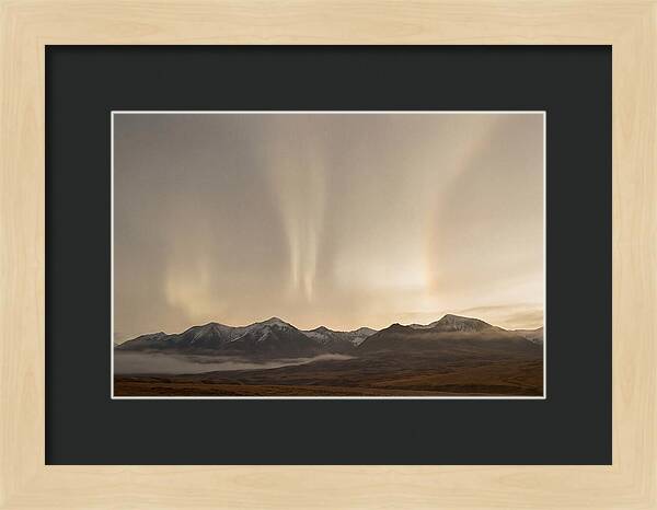 Aurora Pillars Rising Above Mountains