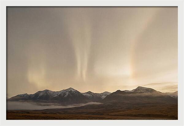 Aurora Pillars Rising Above Mountains