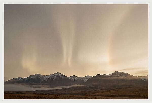 Aurora Pillars Rising Above Mountains
