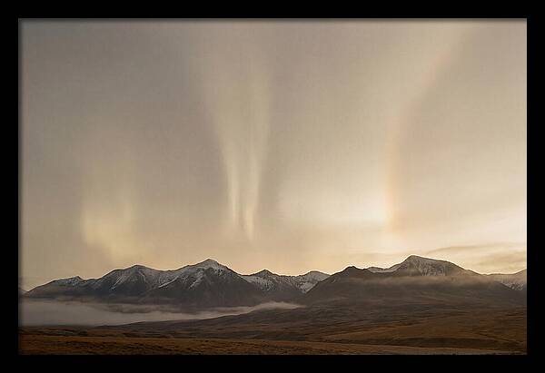 Aurora Pillars Rising Above Mountains