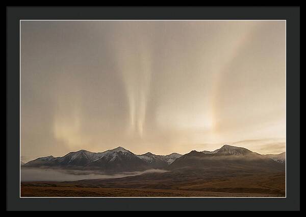 Aurora Pillars Rising Above Mountains
