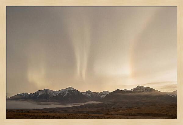 Aurora Pillars Rising Above Mountains