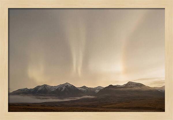 Aurora Pillars Rising Above Mountains