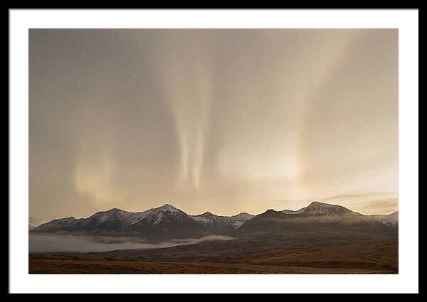 Aurora Pillars Rising Above Mountains
