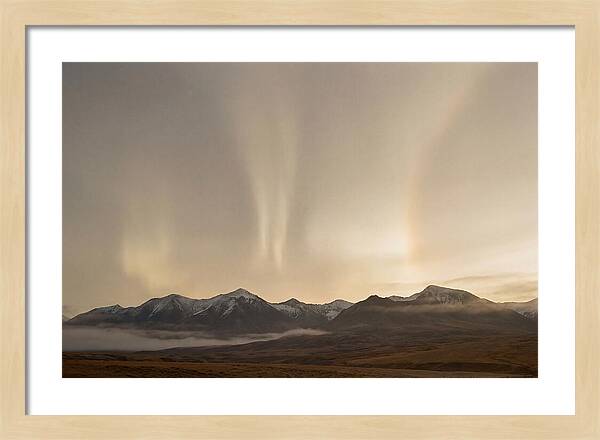 Aurora Pillars Rising Above Mountains