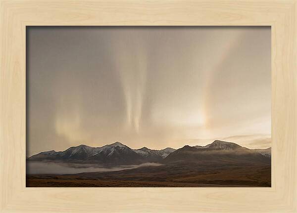 Aurora Pillars Rising Above Mountains