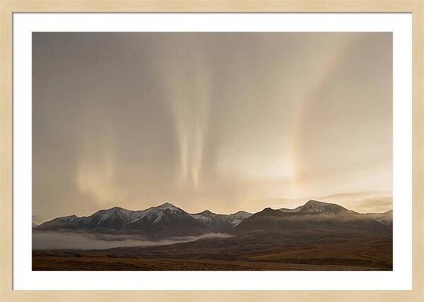 Aurora Pillars Rising Above Mountains