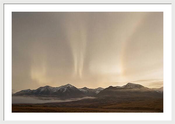 Aurora Pillars Rising Above Mountains
