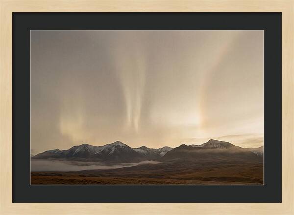 Aurora Pillars Rising Above Mountains