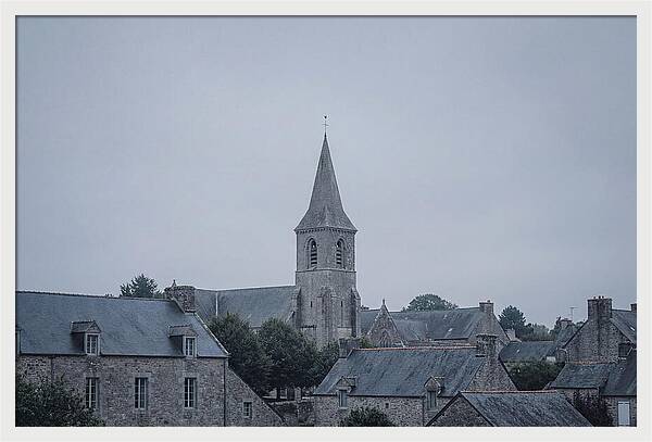 Bell Tower Rising Above Rooflines