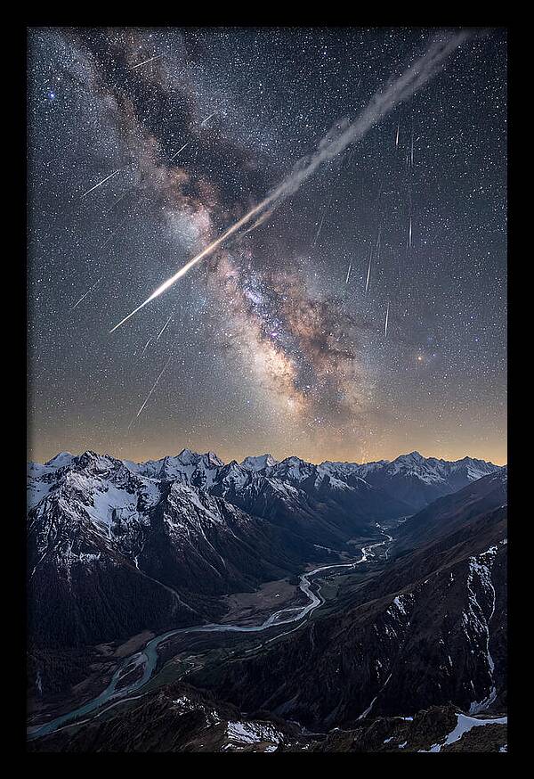Celestial Dance Above Rugged Peaks