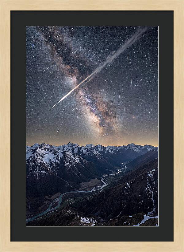 Celestial Dance Above Rugged Peaks
