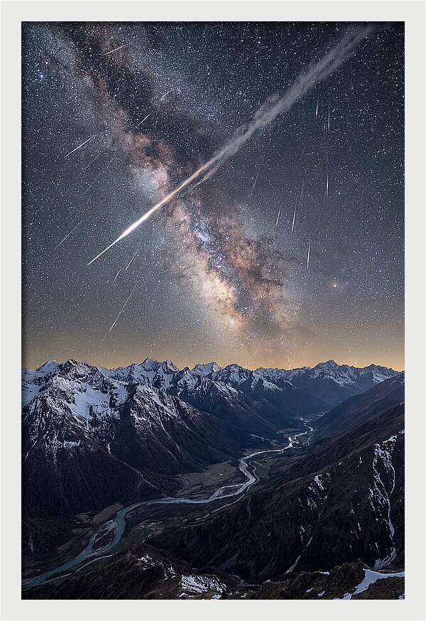 Celestial Dance Above Rugged Peaks