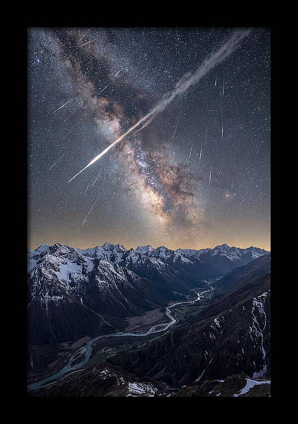 Celestial Dance Above Rugged Peaks