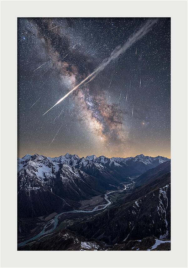 Celestial Dance Above Rugged Peaks