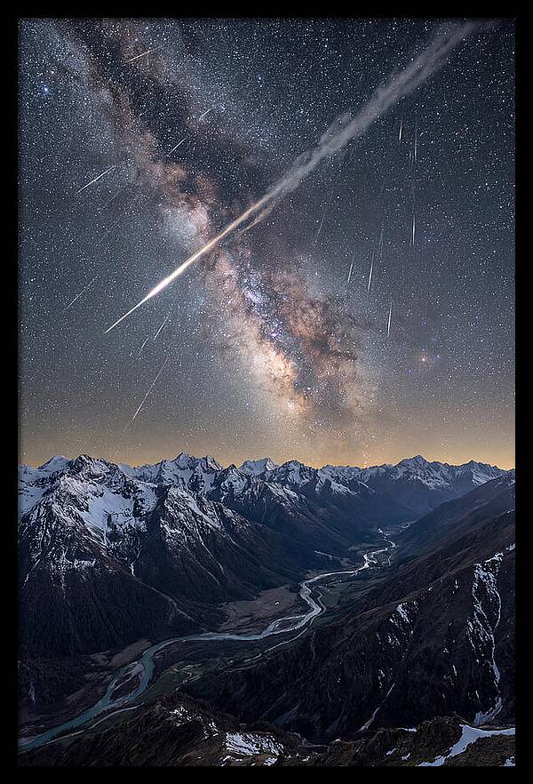 Celestial Dance Above Rugged Peaks
