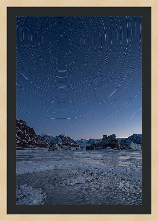 Celestial Star Trails Over Arctic Landscape