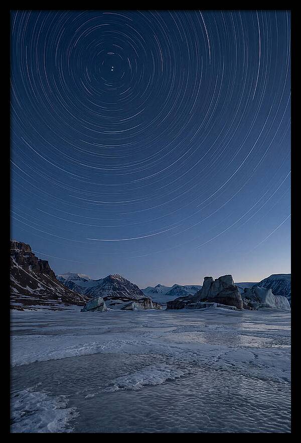 Celestial Star Trails Over Arctic Landscape