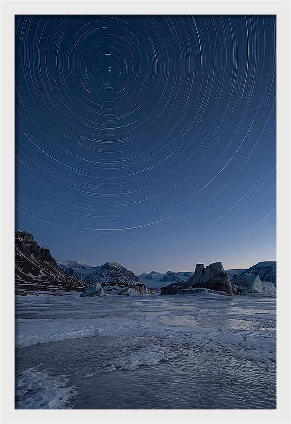 Celestial Star Trails Over Arctic Landscape