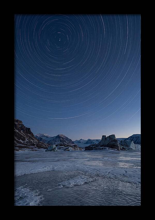 Celestial Star Trails Over Arctic Landscape