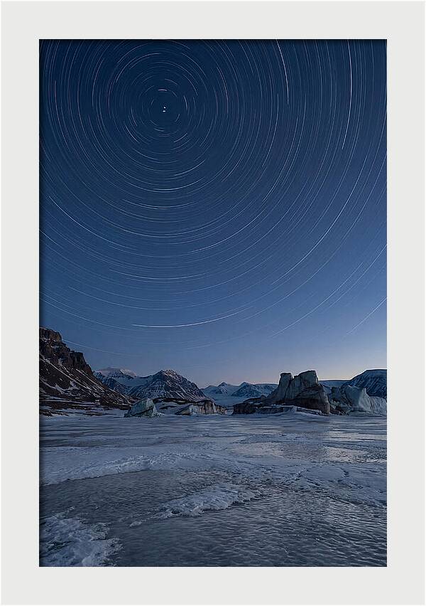 Celestial Star Trails Over Arctic Landscape