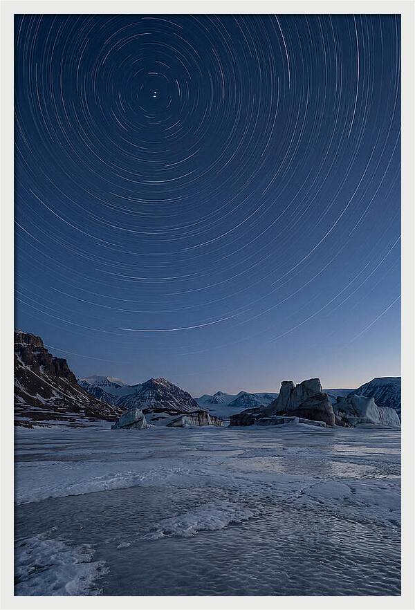 Celestial Star Trails Over Arctic Landscape