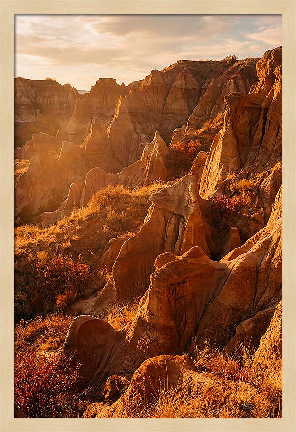 Eroded Mudstone Formations At Sunset