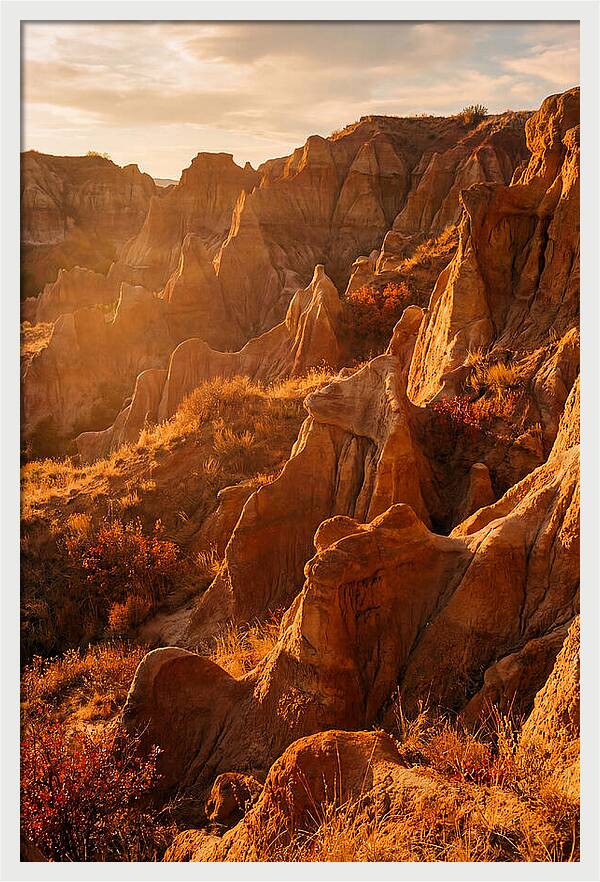 Eroded Mudstone Formations At Sunset
