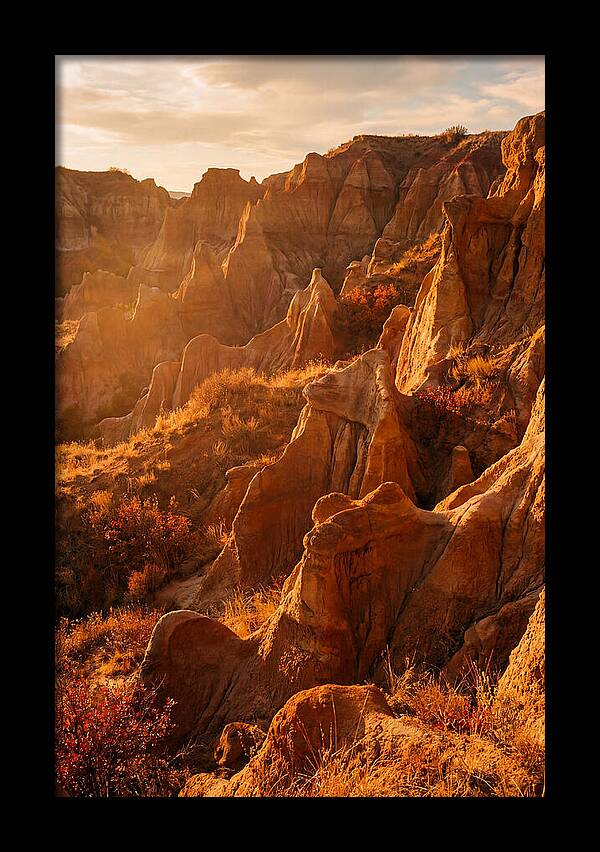 Eroded Mudstone Formations At Sunset
