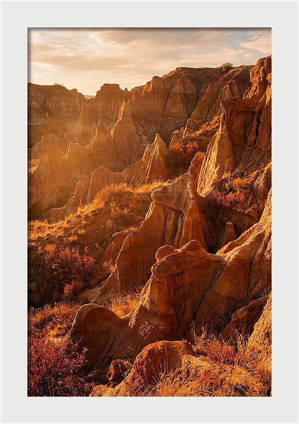 Eroded Mudstone Formations At Sunset