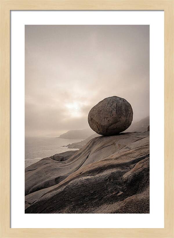 Glacial Erratic Balancing Above Waves
