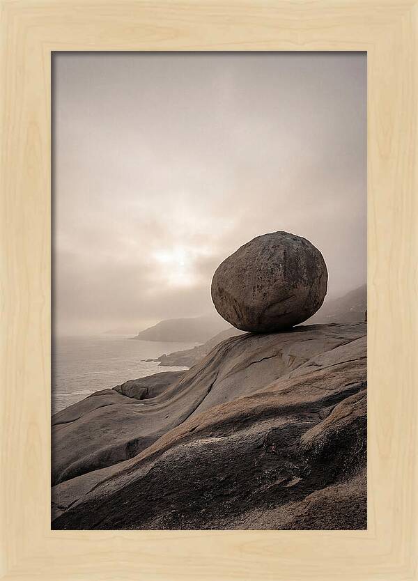Glacial Erratic Balancing Above Waves