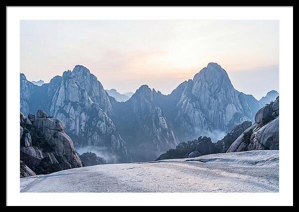 Granite Peaks Piercing Pale Sky