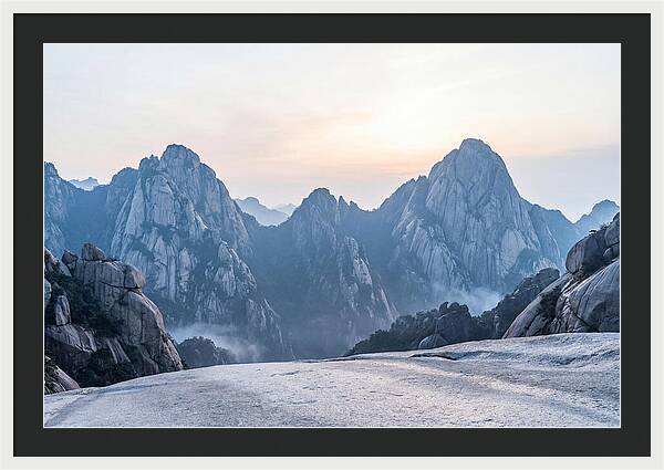 Granite Peaks Piercing Pale Sky