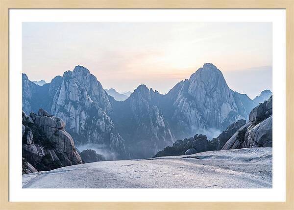 Granite Peaks Piercing Pale Sky