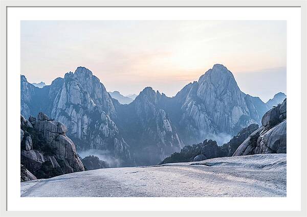 Granite Peaks Piercing Pale Sky