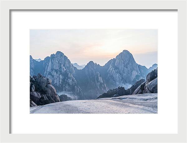 Granite Peaks Piercing Pale Sky