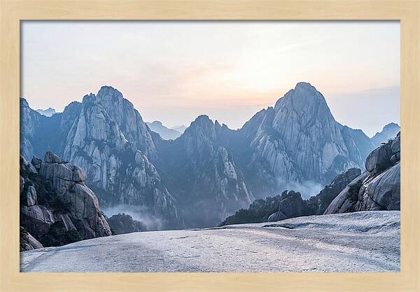 Granite Peaks Piercing Pale Sky
