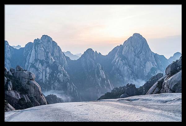 Granite Peaks Piercing Pale Sky