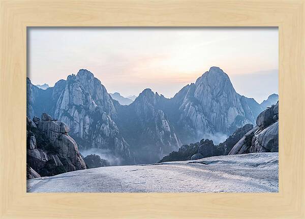 Granite Peaks Piercing Pale Sky