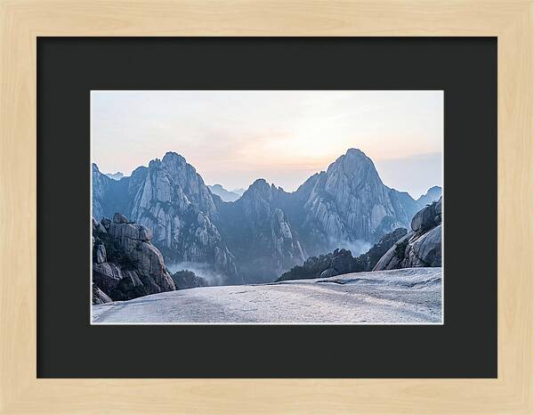 Granite Peaks Piercing Pale Sky