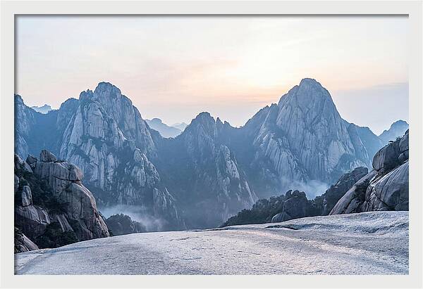 Granite Peaks Piercing Pale Sky